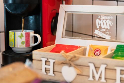 a table with a cup and a box with a mug at La Casa dei Mori in Centuripe