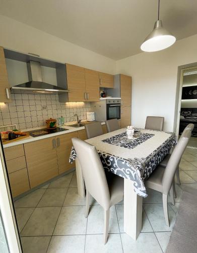 a kitchen with a dining room table with chairs and a table cloth at La Casa dei Mori in Centuripe