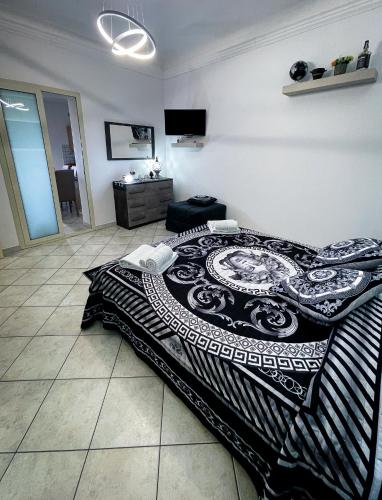 a bedroom with a bed with a black and white blanket at La Casa dei Mori in Centuripe