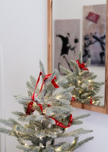 a silver christmas tree in front of a mirror at La Casa dei Mori in Centuripe