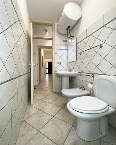 a bathroom with two toilets and a sink at La Casa dei Mori in Centuripe