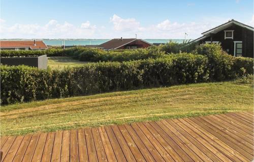a hedge in front of a yard with a house at Holiday Home Lerskrænten Vinderup I in Vinderup