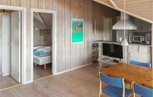 a room with a dining table and a bedroom at Holiday Home Lerskrænten Vinderup I in Vinderup