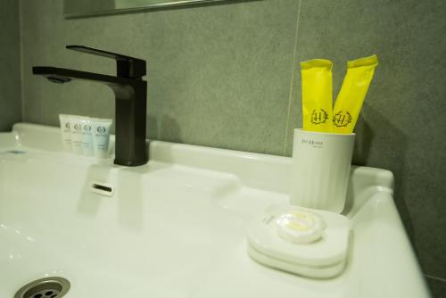 a bathroom sink with a faucet and a mirror at RumHotel in Bishkek