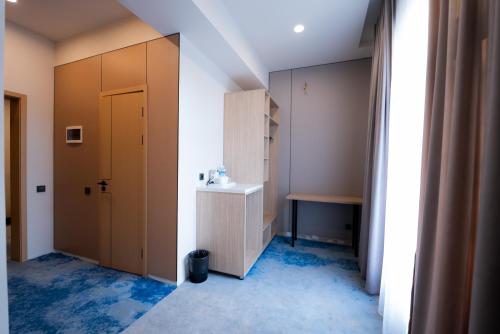 a small bathroom with a sink and a mirror at RumHotel in Bishkek