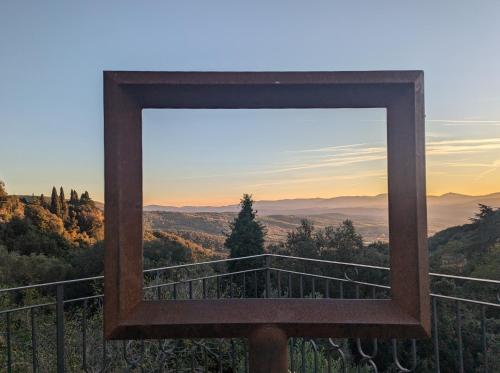 a mirror on a balcony with a view of the mountains at Il Palazzo, Le Fornaci in Sassetta