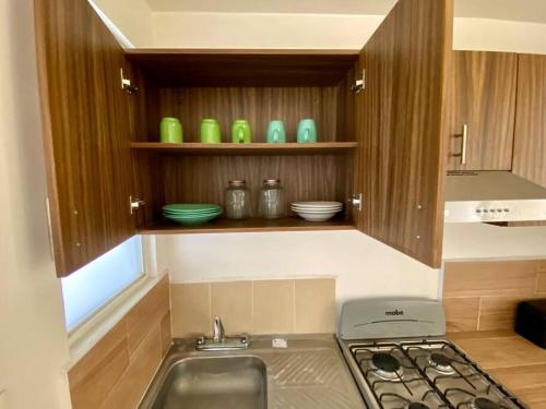 a kitchen with a sink and a stove in it at Rincón ámbar in San Carlos