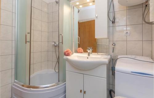 a bathroom with a sink and a shower and a toilet at Holiday Home Vojnic Sinjski 11 in Vojnić Sinjski