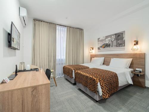 Postel nebo postele na pokoji v ubytování TA Collection Hotel