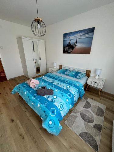 a bedroom with a blue bed with a blue blanket at NO NAME in Koprivnica