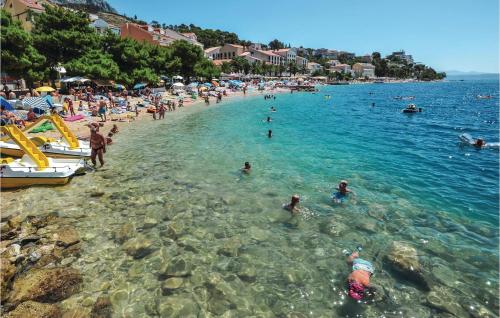 a group of people in the water at a beach at 2 Bedroom Gorgeous Apartment In Podaca in Podaca