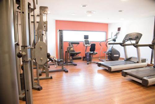 a gym with several treadmills and exercise bikes at Libertador Hotel in Buenos Aires