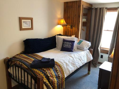 a bedroom with a crib with a pillow on it at Hawkeyes Rest in Johnsburg
