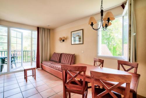 a living room with a table and a couch at Résidence Le Parc d'Arradoy - maeva Home - Appartement 2 pièces 5 personnes - Sélection MAE-2374 in Uhart-Cize