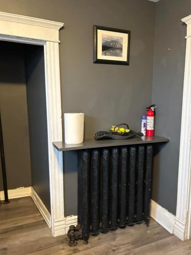 a black radiator in a room with a wall at Maryland Homestay in Winnpeg downtown in Winnipeg