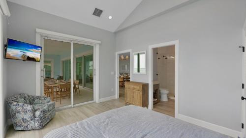 a bedroom with a bed and a dining room at Oceanfront Oasis by Last Key Realty in Key West