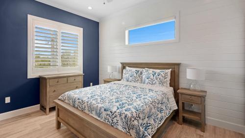a bedroom with a bed and two night stands and a window at Oceanfront Oasis by Last Key Realty in Key West