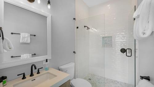a bathroom with a shower and a toilet and a sink at Oceanfront Oasis by Last Key Realty in Key West