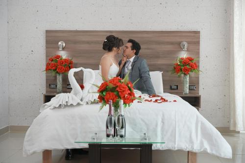 a bride and groom are sitting on a table at Hoteles Gutiérrez Mansión in Arequipa