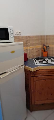 a kitchen with a white stove and a white refrigerator at Très belle location touristique in Sainte-Anne