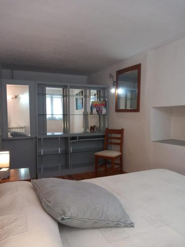 a bedroom with a bed and a desk with a chair at Casa do Paço com Jardim Privado - Centro de Terras de Bouro, Gerês in Terras de Bouro