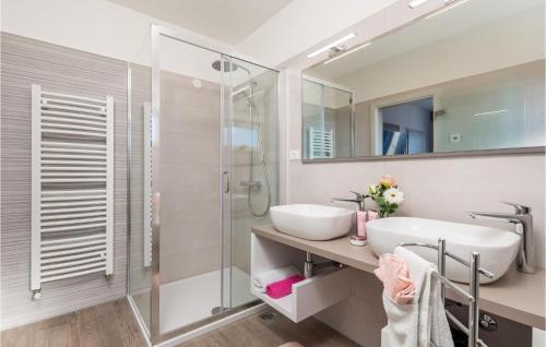 a bathroom with a sink and a shower at Cozy Home In Punat With Sauna in Punat