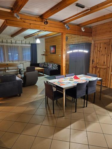 a living room with a table and chairs at Domek Domino in Korbielów