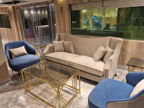 a living room with a couch and two chairs and a table at Nile Cruise 3 & 4 & 7 Nights in Luxor