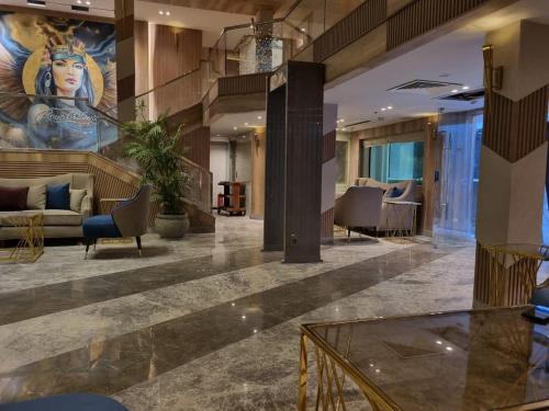 a lobby with a mural of a woman on the wall at Nile Cruise 3 & 4 & 7 Nights in Luxor