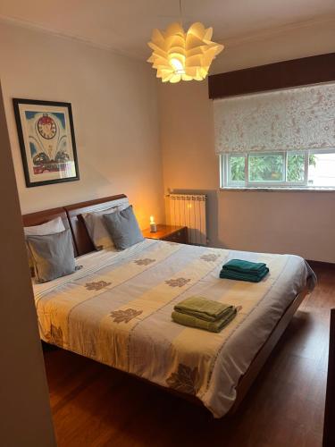 a bedroom with a bed with two towels on it at Relaxing Guesthouse - Sónias Houses in Lisbon