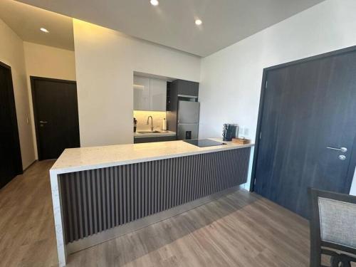 a large kitchen with a counter and a sink at Exclusive Luxury Condo 2bd in Tijuana