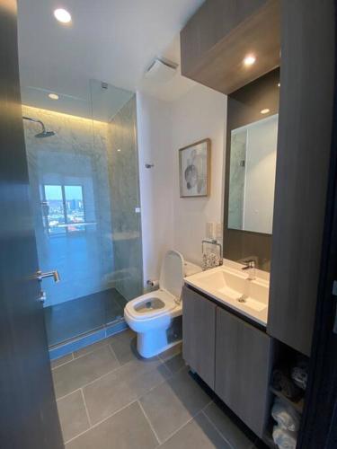 a bathroom with a toilet and a sink at Exclusive Luxury Condo 2bd in Tijuana