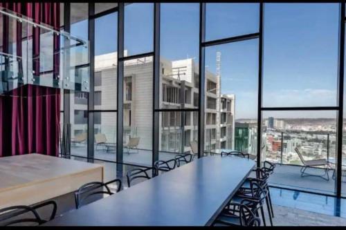 a large room with tables and chairs and windows at Exclusive Luxury Condo 2bd in Tijuana