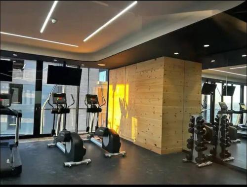 a gym with several treadmills and exercise bikes at Exclusive Luxury Condo 2bd in Tijuana