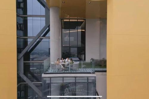 a group of people sitting on a balcony in a building at Exclusive Luxury Condo 2bd in Tijuana