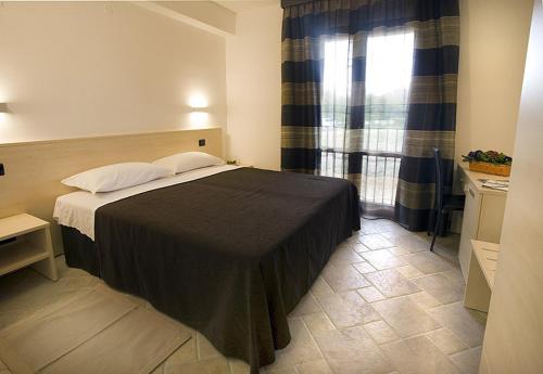 a bedroom with a bed and a window at Villa Giovina in Pratola Peligna
