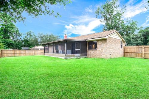a brick house with a fence and a yard at Summer Spot! Glimmering Jacksonville Getaway By Mayo in Jacksonville