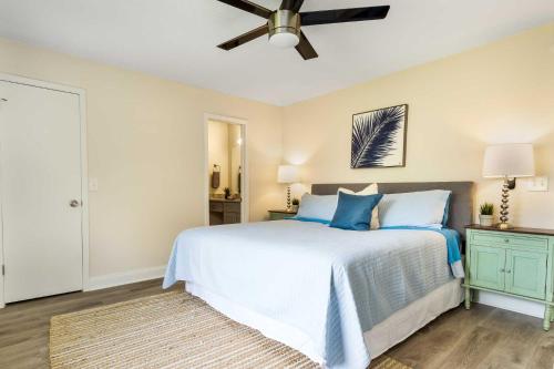 a bedroom with a bed with blue pillows and a ceiling fan at Summer Spot! Glimmering Jacksonville Getaway By Mayo in Jacksonville