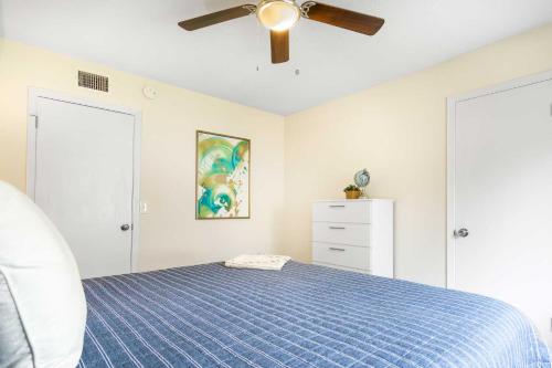 a bedroom with a blue bed and a ceiling fan at Summer Spot! Glimmering Jacksonville Getaway By Mayo in Jacksonville