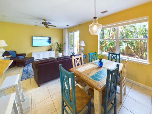 a dining room and living room with a table and chairs at Coastal Bliss Retreat - Beach Vibes & Rockets in Cocoa Beach