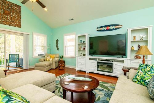a living room with a large flat screen tv at Aloha Breeze Pet Friendly House Near Beach in Myrtle Beach