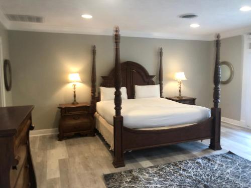 a bedroom with a bed and two night stands and two lamps at The Inn at Cedar Grove in Vicksburg