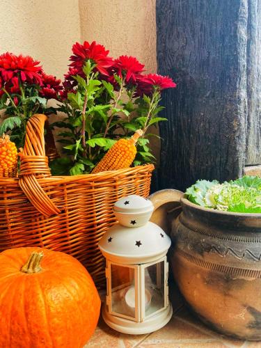 a table with a pumpkin and a lantern and flowers at Bukovički mir in Arandjelovac