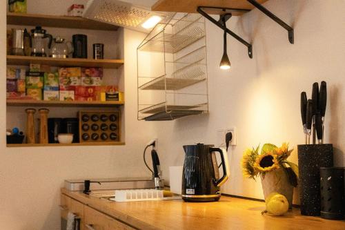 a kitchen with a counter top with a blender and flowers at Pod Gromadzyniem Resort in Ustrzyki Dolne