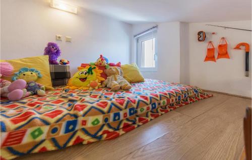 a bedroom with a large bed with stuffed animals on it at Nice Apartment In Barbariga With Wifi in Barbariga