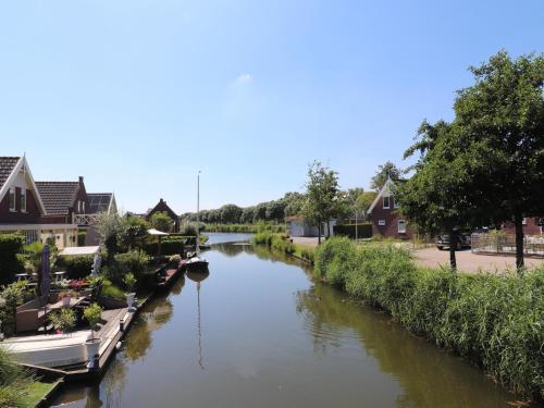a river with boats parked on the side of it at Sun-Soaked Bungalow in Simonshaven in Simonshaven