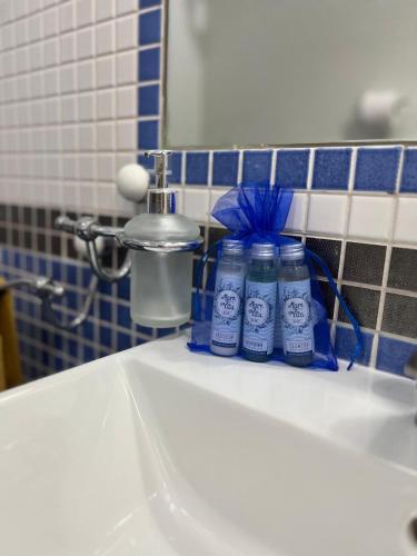 two bottles of toothpaste sitting on a bathroom sink at Casa Vacanza IMPARO B&B Ischia in Ischia