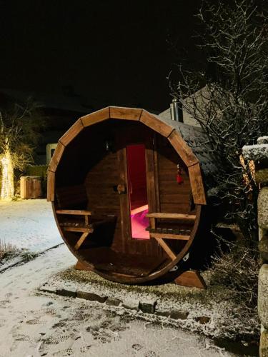 a wooden barrel with a door in the middle at Zeleny Dom Vysoké Tatry in Stará Lesná