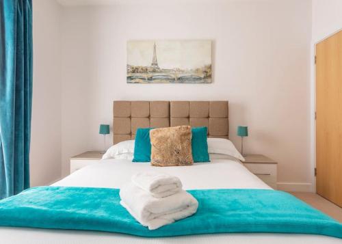 a bedroom with a bed with towels on it at Castle Haven, Redhill in Redhill