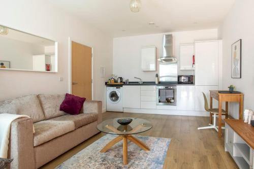 a living room with a couch and a table at Castle Haven, Redhill in Redhill